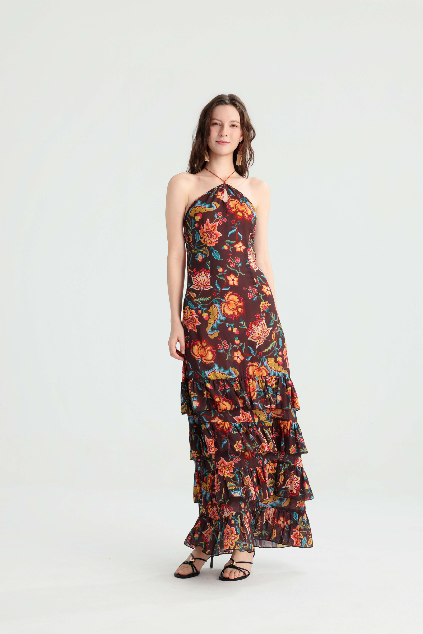 Model standing with one foot forward in the multicolor floral ruffle maxi dress